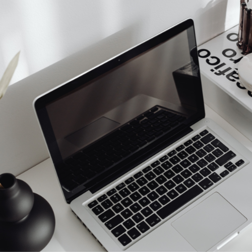 Primer plano de ordenador portátil en oficina moderna para la sección de Prevención del acoso laboral y sexual.